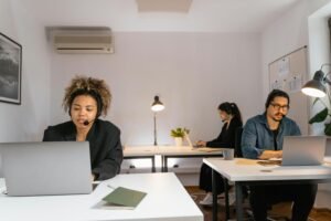 Team of diverse individuals in a modern office setting, working together efficiently.